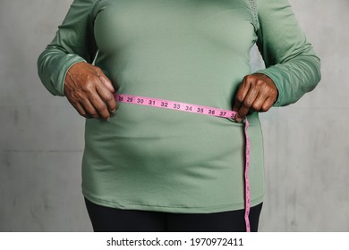 Black woman measuring her tummy - Shutterstock ID 1970972411