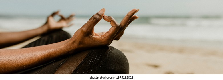 Black Woman Meditating On The Beach