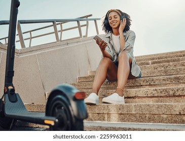 Black woman outdoor, smartphone and headphones with scooter, music and travel with 5g network for audio streaming in city. Sustainable transportation, listen to audio or podcast and relax on steps - Powered by Shutterstock