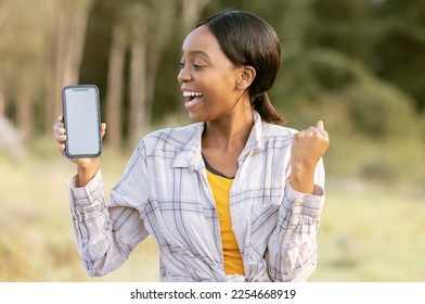 Black woman, phone and mockup display for winning, discount or sale with smile in nature. Happy African American female smiling for giveaway prize, deal or achievement on smartphone in the outdoors - Shutterstock ID 2254668919