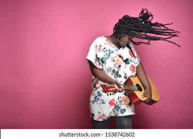 Black Woman Playing A Guitar, Rocking Hard, Hair Flying The Air