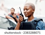 Black woman, police and walkie talkie for radio in city communication, reinforcement or emergency. African female person, security guard or cop calling backup for crime on patrol in urban town street
