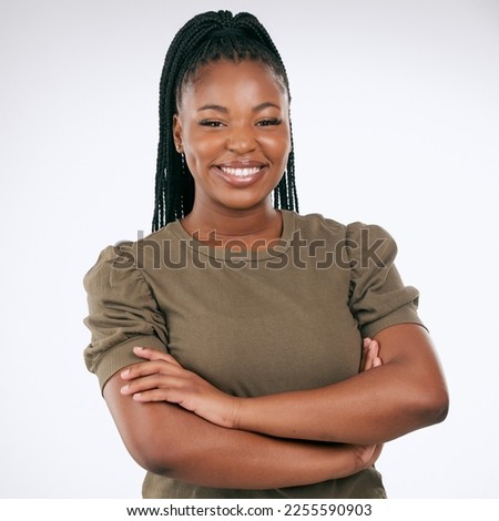 Black woman, portrait and smile with arms crossed in studio with casual style, fashion and confidence. Happy young female model, empowerment and happiness with hair braids, beauty or pride in Nigeria