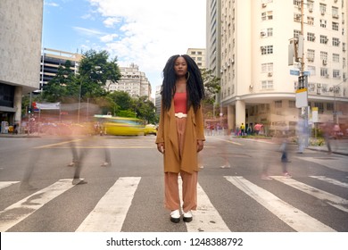 Black Woman Powerful Portrait in The Middle of The Street, Blurred Traffic in a Chaotic Rush Time of a Capital  - Powered by Shutterstock