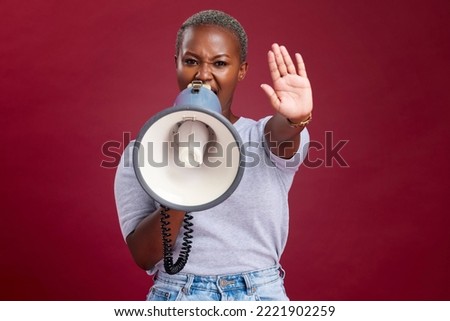 Black woman, protest and shouting with megaphone for voice, strike or stop against a studio background. Portrait of African female activist with hand gesture, vocal or stand for gender based violence