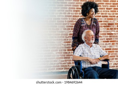 Black Woman Pushing Her Patient's Wheelchair