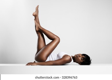 black woman put up her legs and crossed them