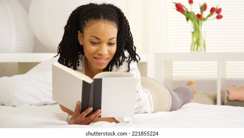 Black Woman Reading On Bed