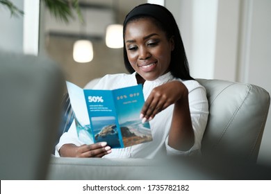 Black Woman Reading Flyer for Holiday Trip