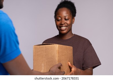 Black Woman Receiving A Package From A Delivery Worker