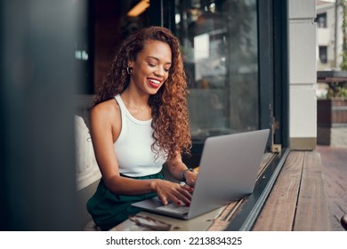 Black Woman, Remote Work On Laptop And Cafe 5g Wifi Network Connection From Coffee Shop Working On Writing Blog Online. Professional Digital Freelancer, Happy Internet Writer And Typing With A Smile