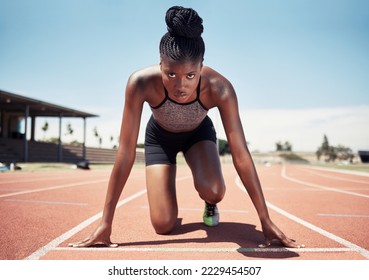 Black woman, runner and start line, race and competition, exercise challenge or fitness at stadium arena. Portrait, focus and sports athlete ready on running track, marathon training and cardio power