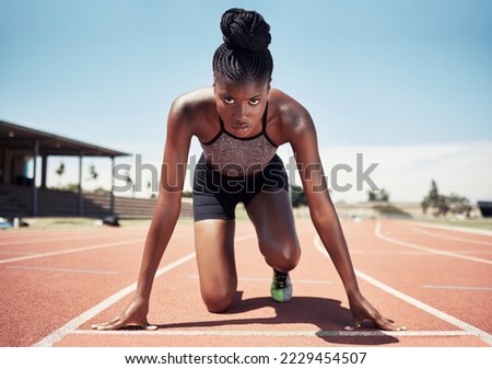 Black woman, runner and start line, race and competition, exercise challenge or fitness at stadium arena. Portrait, focus and sports athlete ready on running track, marathon training and cardio power