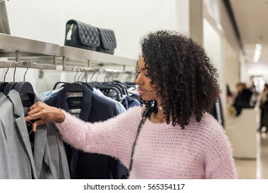 black woman shopping clothes in a store