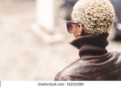 Black Woman With Short Blond Afro Hair Wearing Glasses