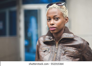 Black Woman With Short Blond Afro Hair Wearing Glasses