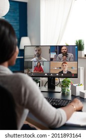 Black Woman Sitting At Desk Working Remote At Marketing Course Ideas Discussing With Virtual Univeristy Team During Online Videocall Meeting Conference, Student Using High School Elearning Platform