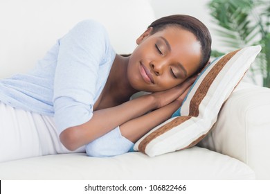 Black Woman Sleeping While Lying On Side In A Living Room