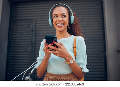 Black woman, smile and phone for social media in the city with headphones in joy for 5G connection in the outdoors. Happy African female student smiling for technology or internet on smartphone - Powered by Shutterstock