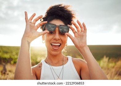 Black Woman Smile, Wink And Happy On Summer Countryside Nature Holiday At Sunset. Girl With Fashion Sunglasses, Laugh With Happiness And Peace On Relax Travel Vacation Trip At South Africa Wine Farm