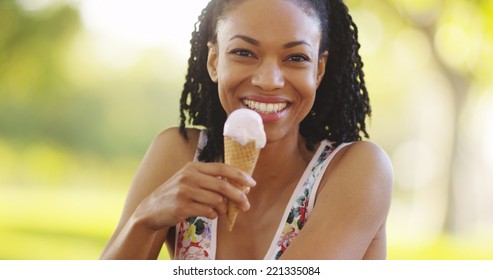 Black Woman Smiling And Eating Ice Cream