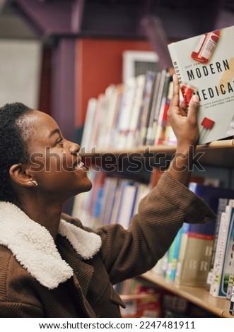 Black woman, student and book in library for medical exam, pills and healthcare education, learning about pharmaceutical drugs. Reading information, learn and study, medicine research with pharmacy