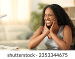 Black woman suffering tmj complaining sitting at home