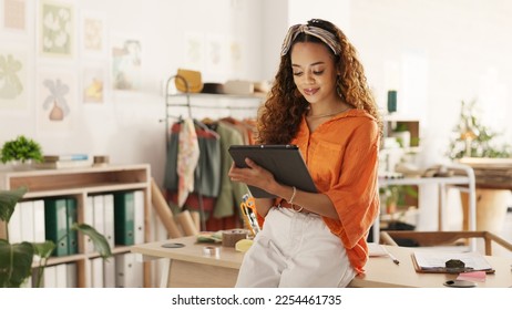 Black woman, tablet and small business in ecommerce, fashion or logistics in remote startup at home. African American female owner working on touchscreen technology in clothing store success - Powered by Shutterstock