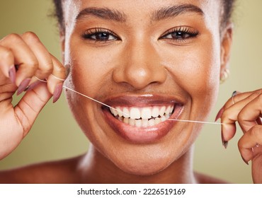 Black woman, teeth and smile for dental floss, skincare or cosmetic treatment against a studio background. Portrait of happy African American toothy female model flossing mouth for clean oral hygiene
