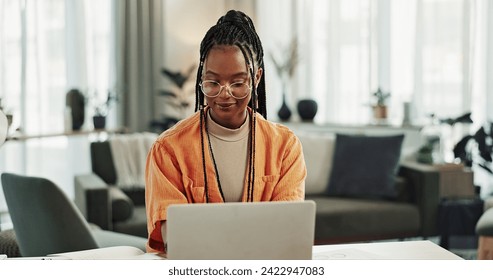 Black woman, typing in home office and laptop for remote work, social media or blog research in apartment. Freelance girl at desk with computer writing email, website post and online chat in house. - Powered by Shutterstock