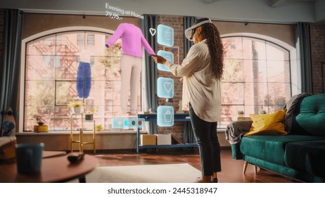 Black Woman Using Virtual Reality Headset for Online Shopping, Browsing through Stylish Clothing items. Ordering from Mock-up Internet Store App for e-Commerce products. Augmented Reality - Powered by Shutterstock