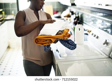 Black Woman Using Washing Machine Doing The Laundry