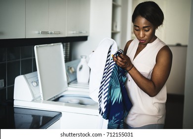 Black Woman Using Washing Machine Doing The Laundry