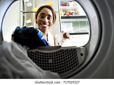 Black Woman Using Washing Machine Doing The Laundry