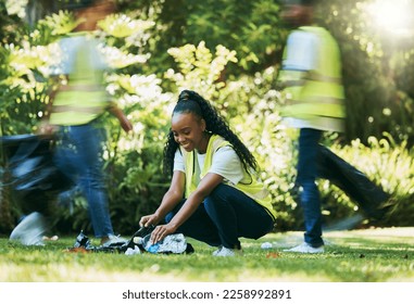 Black woman volunteer, cleaning park and community service for recycling and pollution. Black woman happy to help ngo group with plastic bottle, dirt and trash bag outdoor in green environment - Powered by Shutterstock