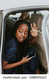 Black Woman Waving Goodbye From A Car