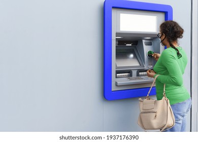 Black Woman Wearing Protective Mask While Withdrawing Money At ATM.