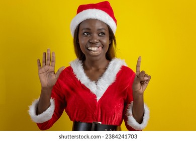 Black woman wearing Santa Claus outfit in studio photo - Powered by Shutterstock