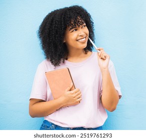 Black woman, writer and thinking with notebook, smile and daydreaming for project, notes and girl on blue studio background. Jamaican female, lady and creative with ideas, decisions or happy student - Powered by Shutterstock