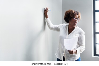 Black Woman Writing On A Whiteboard