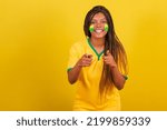 black woman young brazilian soccer fan. pointing at camera, choosing you. photo for advertising. soccer brazil.