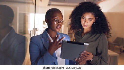 Black women, business and tablet in discussion or meeting for corporate strategy, planning or collaboration at office. African woman executive talking to employee on touchscreen technology at work - Shutterstock ID 2257354023