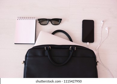 Black Women Leather Business Bag With Laptop, Notebook, Glasses And Smartphone On White Background Top View.