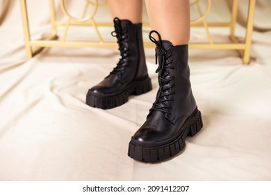 Black women's boots made of genuine leather. New collection of winter shoes for stylish girls. Fashionable women's stylish leather boots.