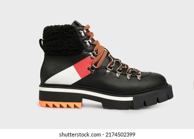 Black women's fashion combat boot isolated on white background. Female classic autumn Timberland shoe. Leather laced, lace up casual footwear with metal rivets, rough sole, fur outside. Template - Shutterstock ID 2174502399