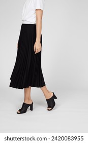 Black women's luxury Classic Long Maxi pleated skirt on model isolated on white background. Woman wearing Midi folded Accordion Skirt, summer autumn outfit. Side view. Template, concept