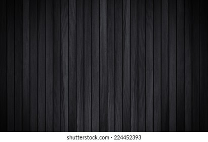 Black wood background. Shadow and vignette dramatic effect.