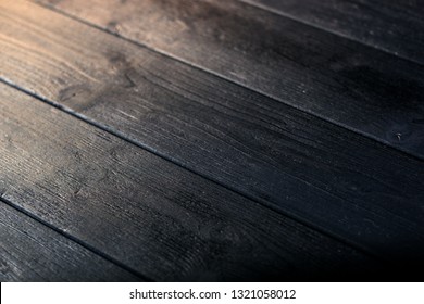 Black Wood Texture, Angle Wise. Dark Background With Natural Soft Light From Left Side. Decorative Closeup Fragment Of Wooden Surface With Shallow Dof.