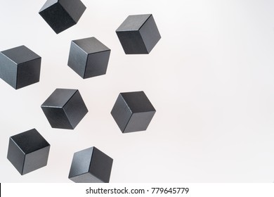 Black wooden cube shapes are floating. Concept of creative, logical thinking. Abstract geometric real floating wooden cube.