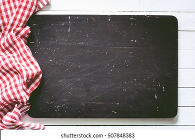 Black Wooden Cutting Board And Red Plaid Textile. Food Background With Copy Space, Horizontal